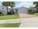 Charming single-Gathering home with a well-manicured lawn, a two-car garage and a brick paver driveway at 3142 Hill Point St, Minneola, FL 34715