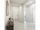 Inviting hallway features tiled floors, neutral walls, white doors, and arched entryways for an elegant appeal at 3142 Hill Point St, Minneola, FL 34715