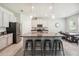 Spacious kitchen with stainless steel appliances, a granite island with barstool seating, and an adjacent dining area at 3142 Hill Point St, Minneola, FL 34715