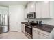 Well-equipped kitchen features stainless steel appliances, ample counter space, and white cabinetry at 3142 Hill Point St, Minneola, FL 34715