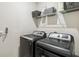 Laundry room featuring a washer, a dryer and a storage basket at 3142 Hill Point St, Minneola, FL 34715