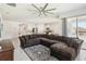 Spacious living room with large sectional sofa and view into the open concept kitchen and patio at 3142 Hill Point St, Minneola, FL 34715