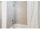 Shower featuring a tub, a shower curtain, and tiled walls at 3142 Hill Point St, Minneola, FL 34715