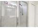 The shower features an adjustable shower head, glass doors, and tiled walls at 3142 Hill Point St, Minneola, FL 34715