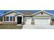 Charming single-Gathering home with a two-car garage and stone accents on the facade at 3305 Arch Ave, Ormond Beach, FL 32174