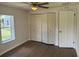 A bedroom featuring a ceiling fan and a closet with folding doors and a window at 3629 Main St, Sanford, FL 32771