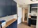 View of kitchen with blue cabinets, butcher block countertops, and stainless steel appliances at 3629 Main St, Sanford, FL 32771