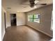 Bright living room with large windows and new laminate flooring, with a view into the kitchen at 3629 Main St, Sanford, FL 32771
