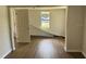 An open living room bathed in natural light, featuring new laminate floors at 3629 Main St, Sanford, FL 32771
