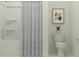Clean bathroom with a tub and shower combination, a white toilet, and modern fixtures at 431 Puma Loop, Groveland, FL 34736