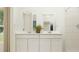Bright bathroom featuring a dual vanity with sleek hardware and a view to the outdoors at 431 Puma Loop, Groveland, FL 34736
