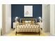 Stylized bedroom with unique rattan bed frame, bold blue wall, and cheerful yellow accents at 431 Puma Loop, Groveland, FL 34736