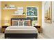 Serene bedroom with a comfortable bed, stylish decor, and natural light from a window at 431 Puma Loop, Groveland, FL 34736