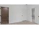 Spacious bedroom with neutral walls, wood-look flooring, and a view into the attached bath at 4572 Sw 149Th St, Ocala, FL 34473