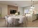 Modern dining area features a round table and stylish pendant lighting near the sleek kitchen at 4572 Sw 149Th St, Ocala, FL 34473