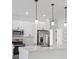 Bright kitchen features a modern island, sleek white cabinets, and stainless steel appliances at 4572 Sw 149Th St, Ocala, FL 34473