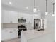 Bright kitchen featuring new appliances, ample counter space, and modern pendant lighting at 4572 Sw 149Th St, Ocala, FL 34473