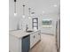 Open-concept kitchen with island, pendant lighting, and stainless steel appliances at 4572 Sw 149Th St, Ocala, FL 34473
