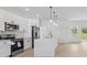 Modern kitchen featuring white cabinetry, stainless steel appliances, and an open layout at 4572 Sw 149Th St, Ocala, FL 34473