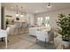 Inviting living space with a modern kitchen, stylish bar stools, and comfortable seating arrangement at 4572 Sw 149Th St, Ocala, FL 34473