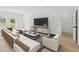 Bright living room with modern furniture, open floor plan, and seamless access to the outdoors at 4572 Sw 149Th St, Ocala, FL 34473