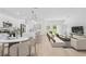 Open concept living room connected to a modern kitchen, featuring ample seating and natural light at 4572 Sw 149Th St, Ocala, FL 34473