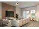 Contemporary living room featuring a sleek entertainment center and comfortable seating with natural light at 4572 Sw 149Th St, Ocala, FL 34473
