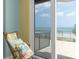Relax on the balcony with ocean views and comfortable seating in this sunny condo at 4631 S Atlantic Ave # 8102, Port Orange, FL 32127