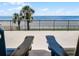 Balcony view with comfortable chairs, offering a serene ocean view at 4631 S Atlantic Ave # 8102, Port Orange, FL 32127