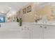 Close up of a bathroom featuring a large soaking tub and white cabinets at 4631 S Atlantic Ave # 8102, Port Orange, FL 32127