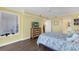 Bright bedroom with balcony access, offering ocean views, TV, and seamless access to other rooms at 4631 S Atlantic Ave # 8102, Port Orange, FL 32127