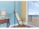 Comfortable bedroom with a rocking chair, offering serene views of the ocean and beach at 4631 S Atlantic Ave # 8102, Port Orange, FL 32127