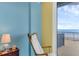 Cozy bedroom nook with a rocking chair, perfect for reading and enjoying the ocean view at 4631 S Atlantic Ave # 8102, Port Orange, FL 32127