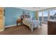 Relaxing bedroom with patterned bedding, beach-themed decor, and access to a private balcony at 4631 S Atlantic Ave # 8102, Port Orange, FL 32127