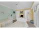 Bright bedroom featuring two beds, decorations and adjacent bathroom at 4631 S Atlantic Ave # 8102, Port Orange, FL 32127