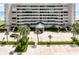 Multi-story condominium featuring a covered entryway, lush landscaping and ample parking at 4631 S Atlantic Ave # 8102, Port Orange, FL 32127