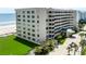 Multi-story condominium with a covered entryway and manicured lawn at 4631 S Atlantic Ave # 8102, Port Orange, FL 32127