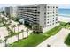 Multi-story condominium featuring a covered entryway and lush landscaping at 4631 S Atlantic Ave # 8102, Port Orange, FL 32127