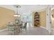 Charming dining area with glass table and chairs with a view of the adjacent living room at 4631 S Atlantic Ave # 8102, Port Orange, FL 32127