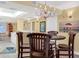 Dining area featuring wood-look floors, chandelier, and seating for four at 4631 S Atlantic Ave # 8102, Port Orange, FL 32127