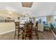 Dining area featuring wood-look floors, chandelier, and seating for four at 4631 S Atlantic Ave # 8102, Port Orange, FL 32127