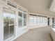 Condominium hallway with multiple windows, a door and tiled floors at 4631 S Atlantic Ave # 8102, Port Orange, FL 32127