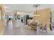 Bright and airy kitchen with white cabinets and stainless steel appliances, open to dining area at 4631 S Atlantic Ave # 8102, Port Orange, FL 32127