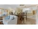 Spacious living room featuring wood-look floors, ceiling fan, and sliding glass doors to patio at 4631 S Atlantic Ave # 8102, Port Orange, FL 32127