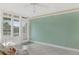 Cozy living room with bead board accent wall, tile floor, and a door to the outdoors at 4631 S Atlantic Ave # 8102, Port Orange, FL 32127