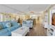 Spacious living room featuring wood-look floors, ceiling fan, and sliding glass doors to patio at 4631 S Atlantic Ave # 8102, Port Orange, FL 32127