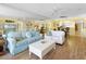 Bright living room features a sofa, ceiling fan, wood floors, and dining area at 4631 S Atlantic Ave # 8102, Port Orange, FL 32127