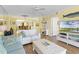 Inviting living room with a ceiling fan, wood floors, sofa, and coastal decor at 4631 S Atlantic Ave # 8102, Port Orange, FL 32127