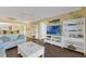 Bright living room with coastal decor, white shelving, and wood-look floors, perfect for relaxing at 4631 S Atlantic Ave # 8102, Port Orange, FL 32127