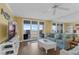 Spacious living room featuring wood-look floors, ceiling fan, and sliding glass doors to patio at 4631 S Atlantic Ave # 8102, Port Orange, FL 32127